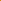 Close-up of orange and green candy sprinkles.